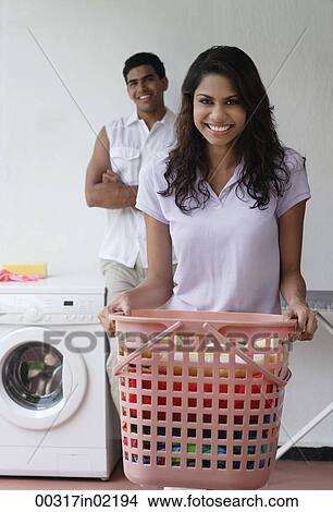 Woman doing laundry and smiling at camera View Large Photo Image Picture - Woman doing laundry and smiling at camera. Fotosearch
