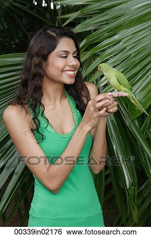Woman with bird on hand View Large Photo Image Stock Photograph - Woman with bird on hand. Fotosearch