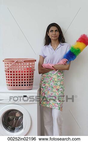 Woman with feather duster, looking at camera View Large Photo Image Stock Photograph - Woman with feather duster, looking at camera. Fotosearch
