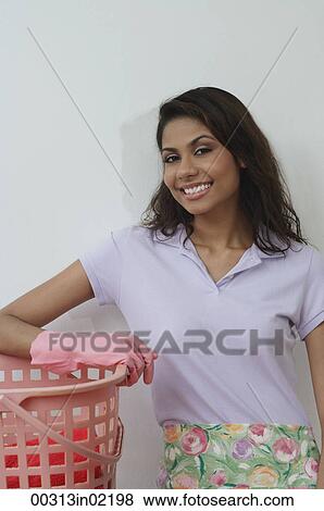 Woman with rubber gloves and washing basket, smiling at camera View Large Photo Image Stock Photo - Woman with rubber gloves and washing basket, smiling at camera. Fotosearch