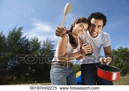 Young couple camping and cooking in the wilderness View Large Photo Image Stock Photography - Young couple camping and cooking in the wilderness. Fotosearch