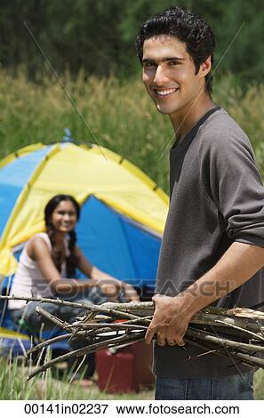 Young couple camping in high grass View Large Photo Image Stock Photo - Young couple camping in high grass. Fotosearch