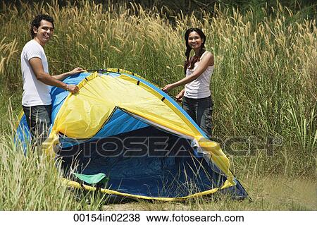 Young couple camping in high grass View Large Photo Image Stock Photo - Young couple camping in high grass. Fotosearch
