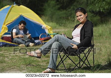 Young couple camping in the wilderness View Large Photo Image Stock Image - Young couple camping in the wilderness. Fotosearch