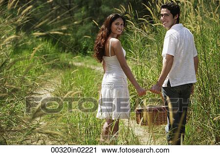 Young couple going for a picnic View Large Photo Image Stock Image - Young couple going for a picnic. Fotosearch