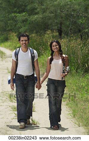 Stock Image - Young couple hiking in the wilderness. Fotosearch