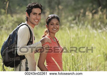 Stock Image - Young couple hiking in the wilderness. Fotosearch