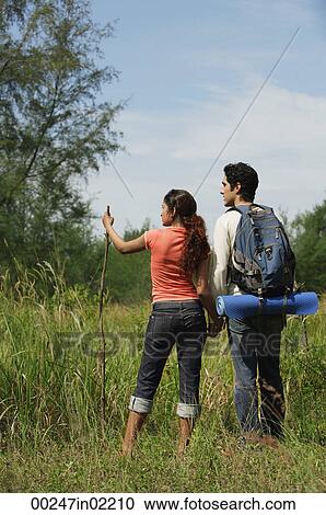 Young couple hiking in the wilderness View Large Photo Image Stock Image - Young couple hiking in the wilderness. Fotosearch