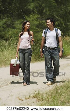 Young couple hiking in the wilderness View Large Photo Image Stock Image - Young couple hiking in the wilderness. Fotosearch