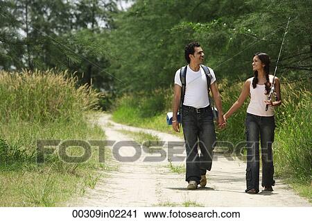 Stock Image - Young couple hiking in the wilderness. Fotosearch