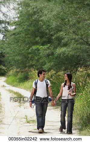 Stock Image - Young couple hiking in the wilderness. Fotosearch