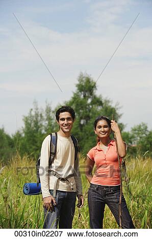 Young couple hiking in the wilderness View Large Photo Image Stock Photo - Young couple hiking in the wilderness. Fotosearch