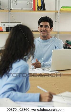 Young couple talking with one another View Large Photo Image Stock Image - Young couple talking with one another. Fotosearch
