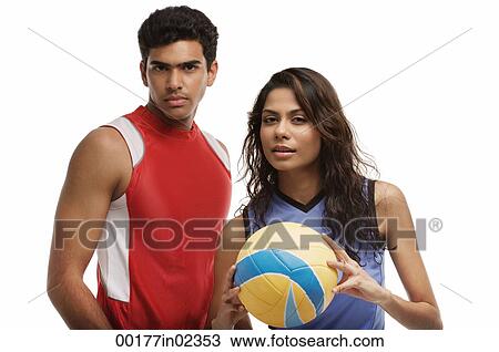 Young couple with beach ball looking at camera View Large Photo Image Stock Image - Young couple with beach ball looking at camera. Fotosearch