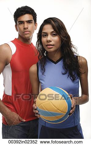 Young couple with beach ball looking at camera View Large Photo Image Stock Image - Young couple with beach ball looking at camera. Fotosearch
