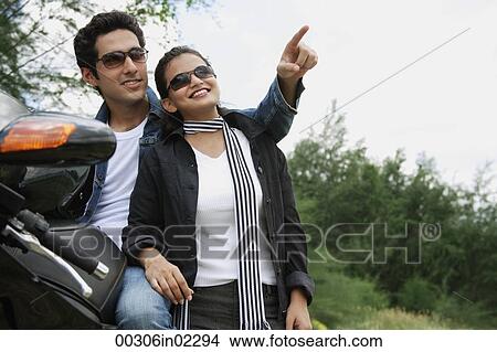 Picture - Young couple with motorbike. Fotosearch