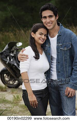 Young couple with motorbike smiling at camera View Large Photo Image Stock Photo - Young couple with motorbike smiling at camera. Fotosearch