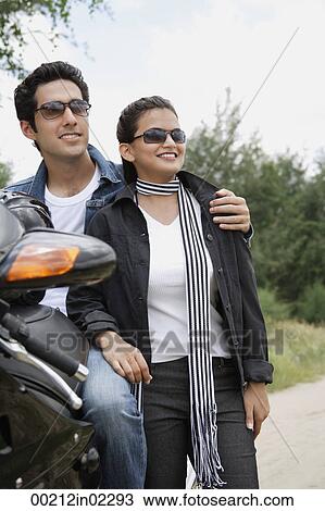 Young couple with motorbike View Large Photo Image Stock Image - Young couple with motorbike. Fotosearch