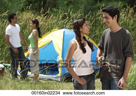 Picture - Young friends camping in the wilderness. Fotosearch