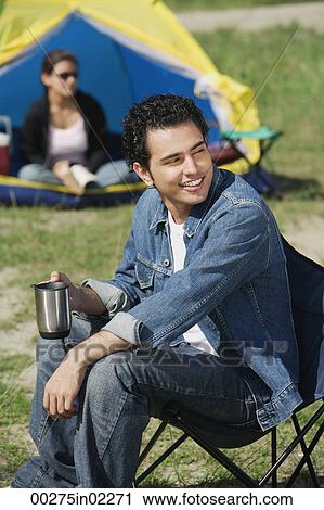 Young man camping with girlfriend View Large Photo Image Stock Image - Young man camping with girlfriend. Fotosearch