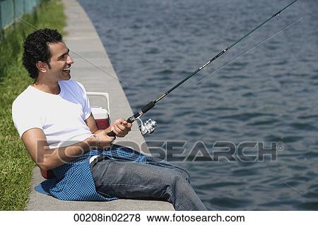 Stock Photo - Young man fishing in river. Fotosearch
