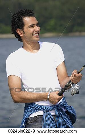 Stock Photo - Young man fishing in river. Fotosearch