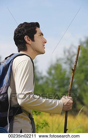 Stock Image - Young man hiking in the wilderness. Fotosearch