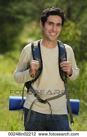 Stock Image - Young man hiking in the wilderness. Fotosearch