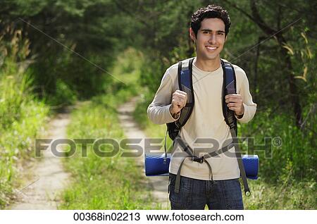 Young man hiking in the wilderness View Large Photo Image Stock Image - Young man hiking in the wilderness. Fotosearch