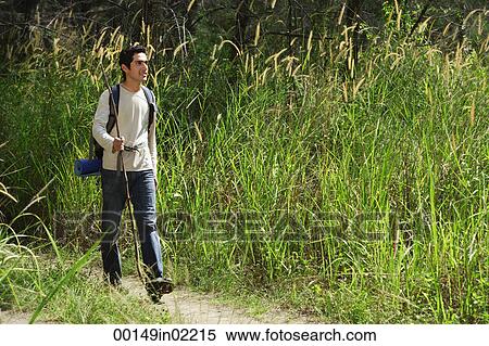 Stock Photography - Young man hiking in the wilderness. Fotosearch