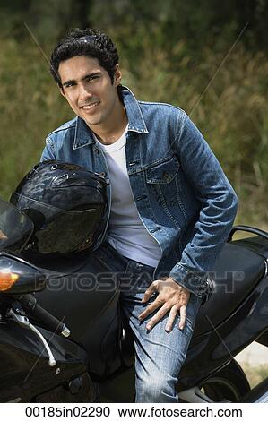 Young man riding motorbike View Large Photo Image Stock Image - Young man riding motorbike. Fotosearch