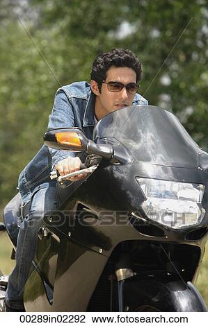 Young man riding motorbike View Large Photo Image Stock Image - Young man riding motorbike. Fotosearch