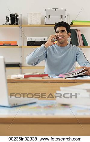 Stock Photo - Young man talking on the phone. Fotosearch