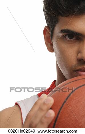 Young man with basketball looking at camera View Large Photo Image Stock Photo - Young man with basketball looking at camera. Fotosearch