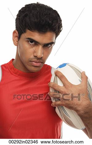 Young man with rugby looking at camera View Large Photo Image Stock Photograph - Young man with rugby looking at camera. Fotosearch
