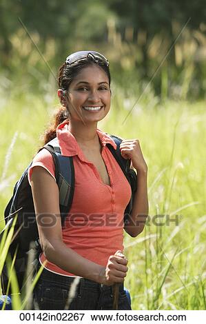 Stock Photo - Young woman hiking in the wilderness. Fotosearch