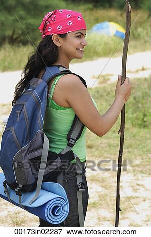 Stock Photo - Young woman hiking. Fotosearch