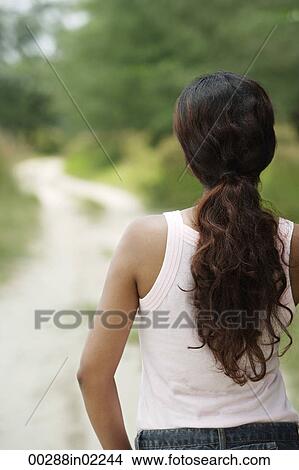 Picture - Young woman looking into distance. Fotosearch