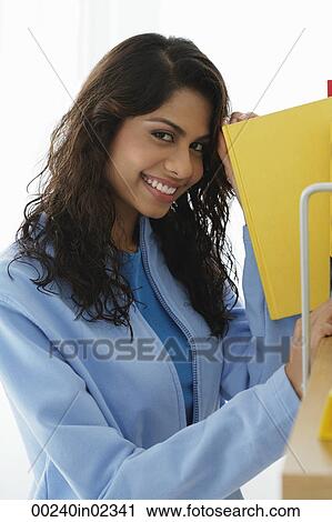 Young woman smiling at camera View Large Photo Image Stock Image - Young woman smiling at camera. Fotosearch
