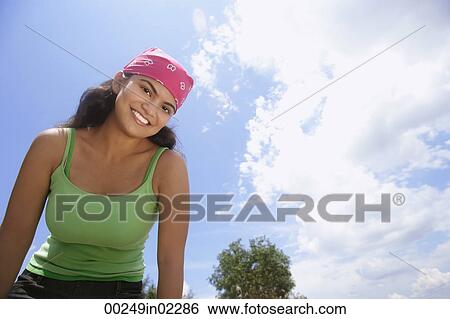 Young woman with bandana smiling at camera View Large Photo Image Stock Photograph - Young woman with bandana smiling at camera. Fotosearch