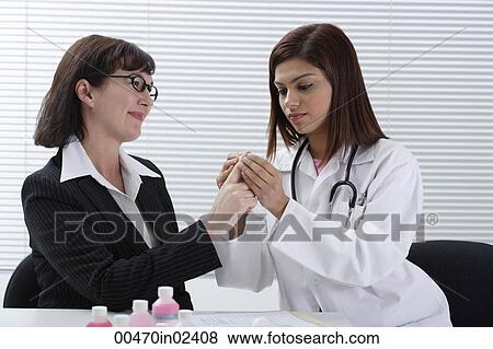 Doctor applying bandage to patient's finger View Large Photo Image Stock Photo - Doctor applying bandage to patient's finger. Fotosearch