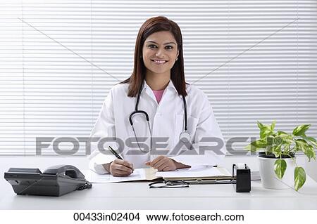 Picture - Doctor at desk. Fotosearch