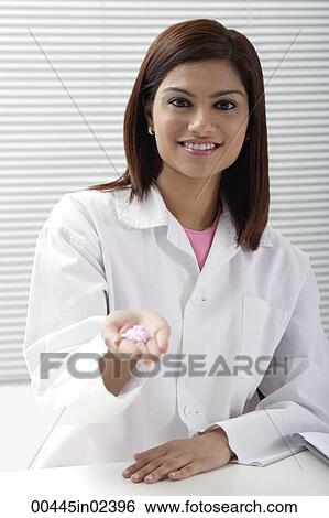 Doctor holding handful of pills View Large Photo Image Stock Photograph - Doctor holding handful of pills. Fotosearch