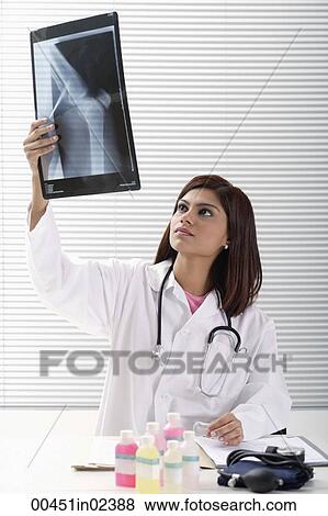 Doctor reading x ray View Large Photo Image Stock Photo - Doctor reading x ray. Fotosearch