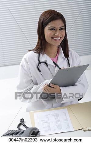 Doctor smiling with report in hand View Large Photo Image Stock Image - Doctor smiling with report in hand. Fotosearch