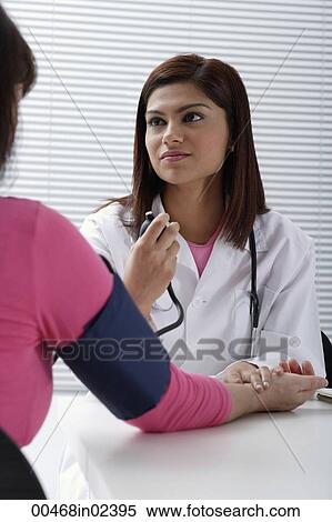 Stock Photography - Doctor taking pulse of patient. Fotosearch