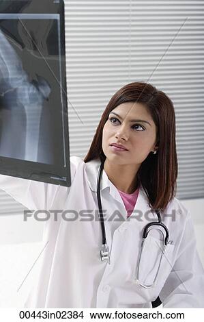 Doctor with x rays View Large Photo Image Picture - Doctor with x rays. Fotosearch