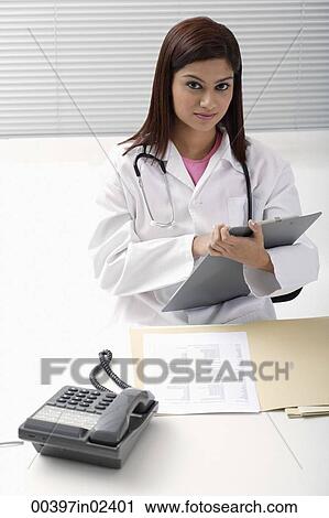 Doctor working on report View Large Photo Image Stock Image - Doctor working on report. Fotosearch