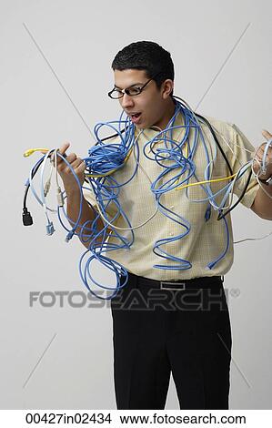 Frustrated man with computer cords and wires View Large Photo Image Picture - Frustrated man with computer cords and wires. Fotosearch