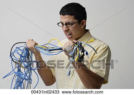 Frustrated man with tangled wires View Large Photo Image Stock Image - Frustrated man with tangled wires. Fotosearch